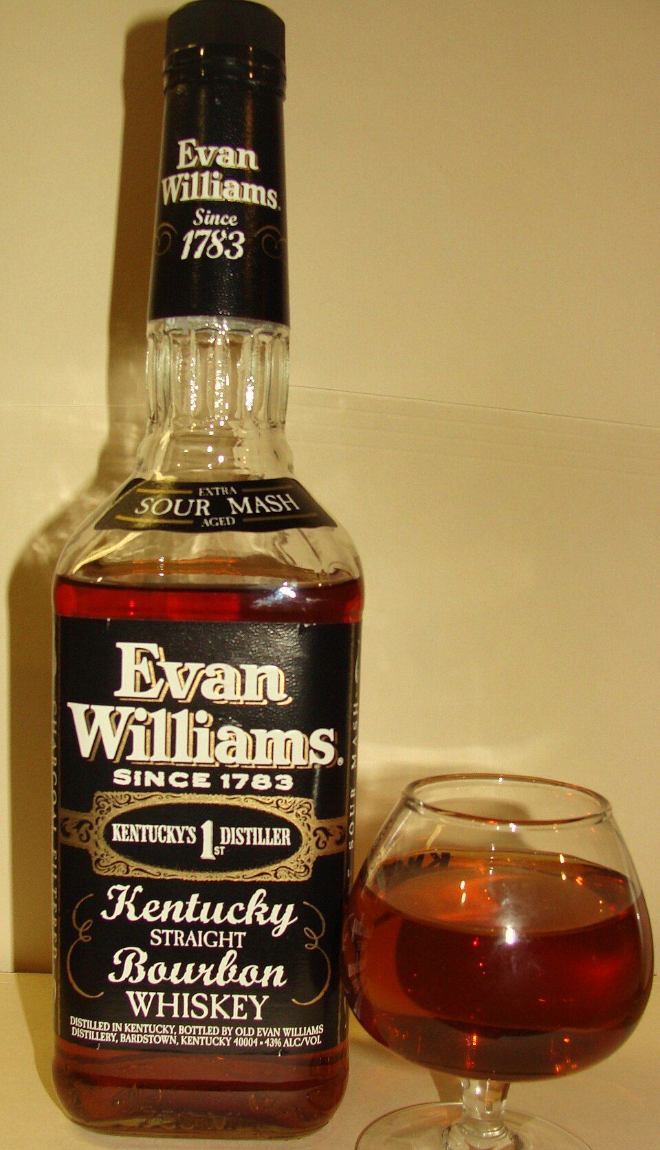 A bottle of Evan Williams bourbon with a glass