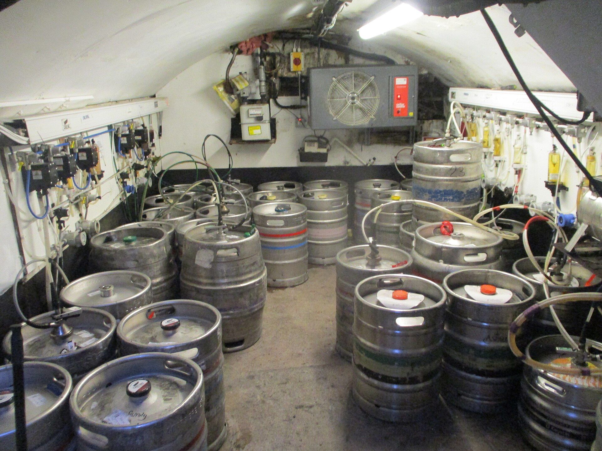 Beer kegs lined up in a cellar
