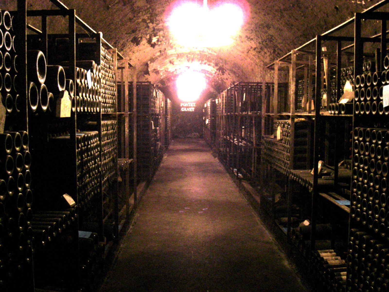 Wine bottles aging in an underground cellar