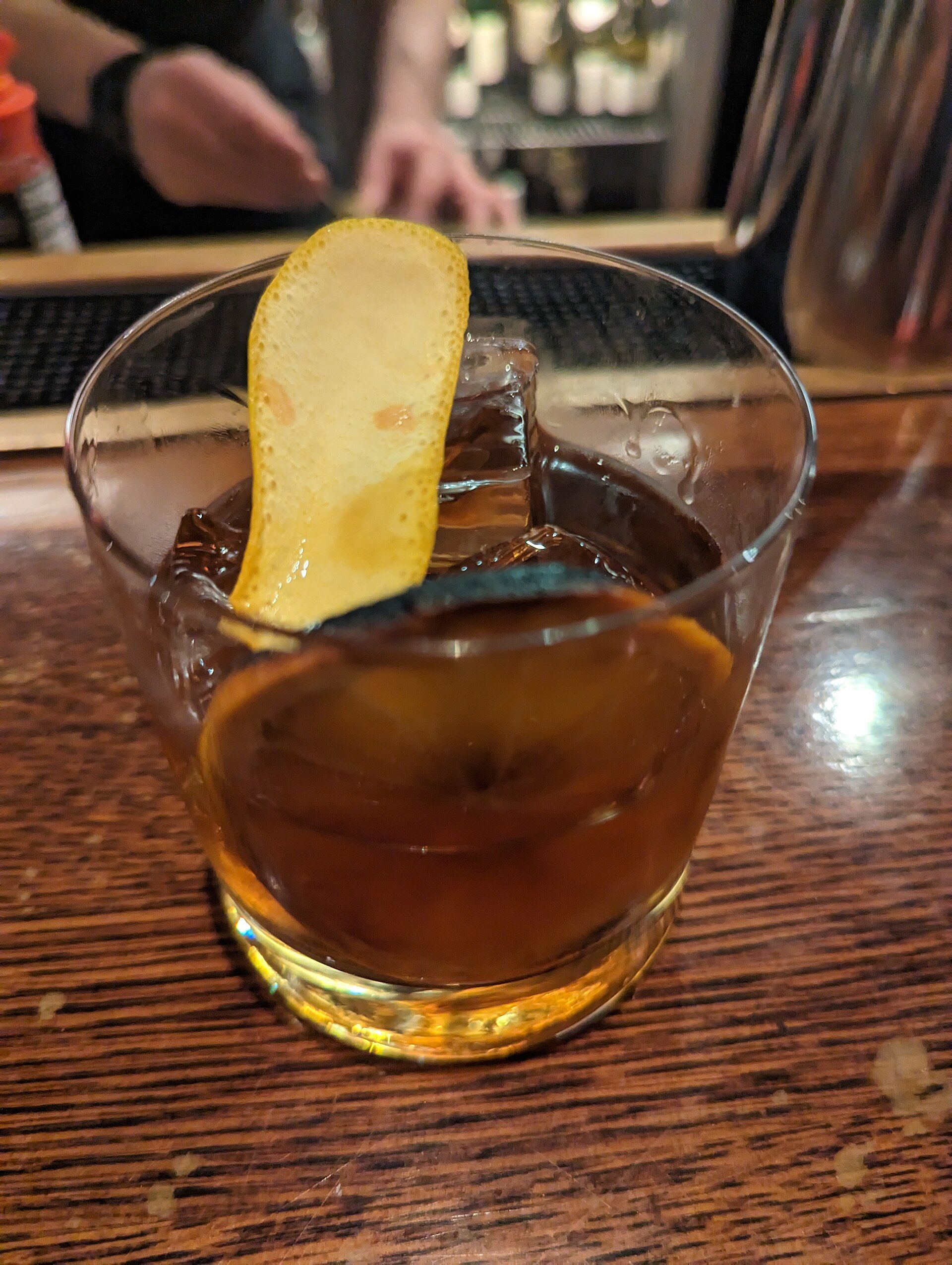 A whiskey cocktail on a bar