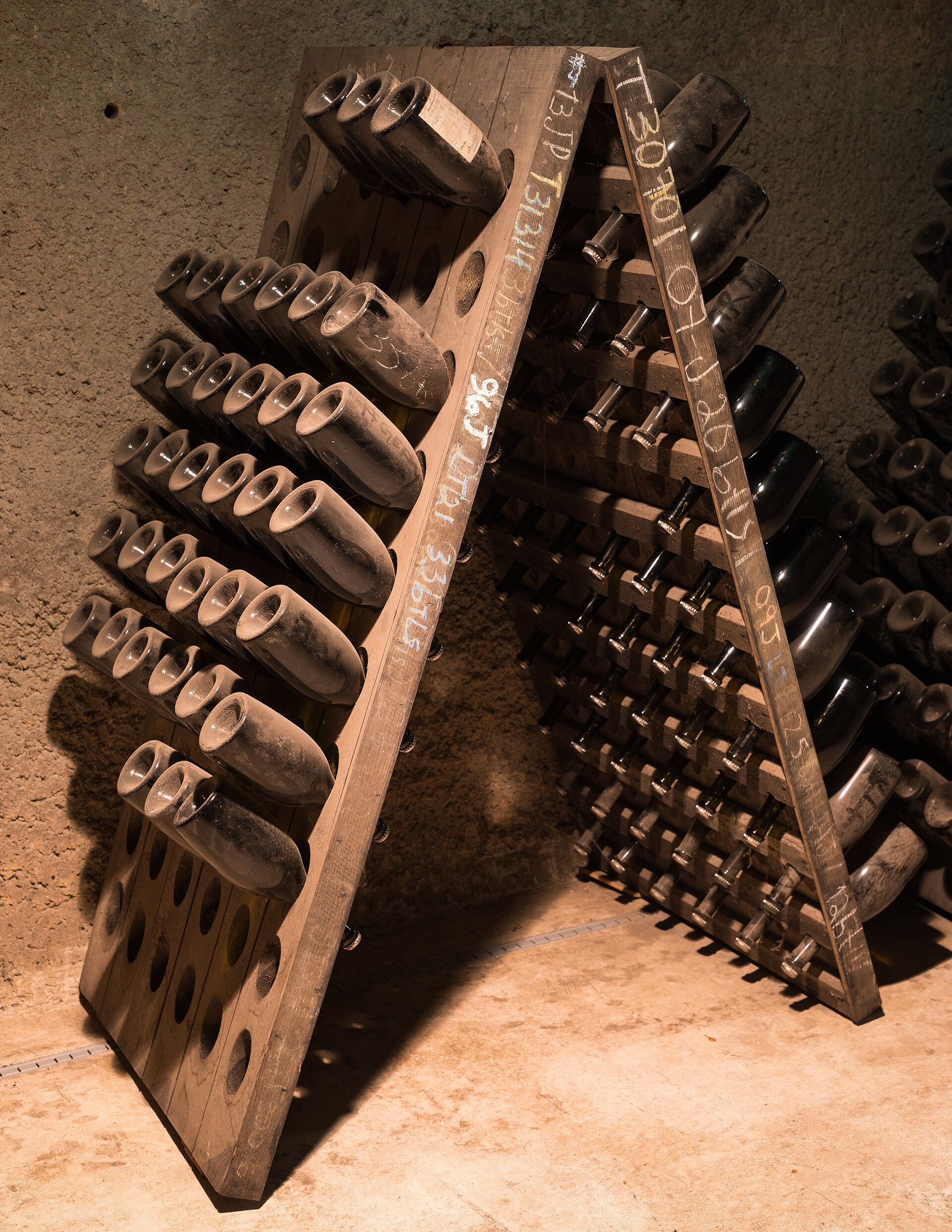 Sparkling wine bottles stacked in a cellar